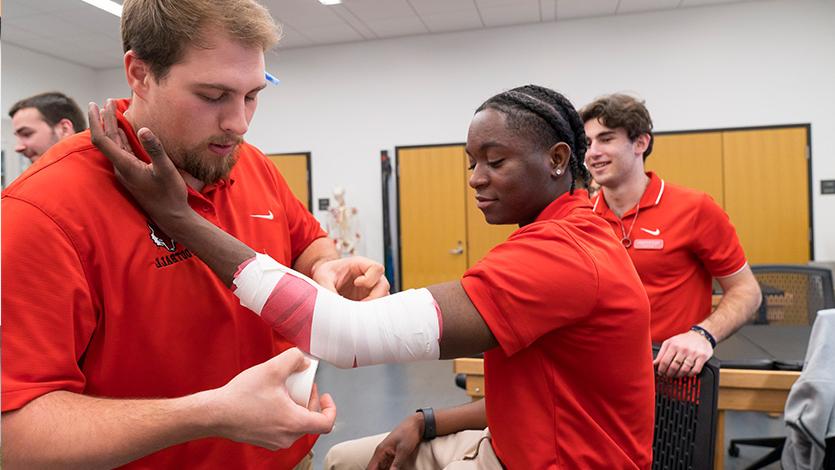 Image of Athletic Training students practice taping and wrapping in the Athletic Training Lab.