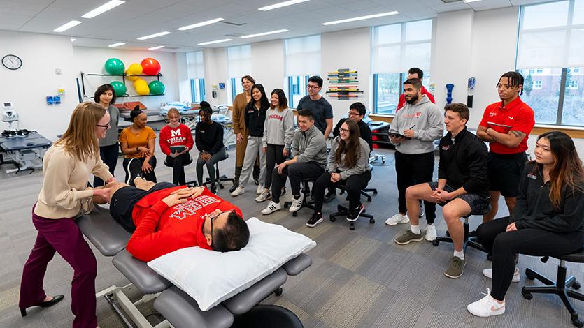 Image of Doctor of Physical Therapy students observe a technique during a class at the DPT Skills Lab. 